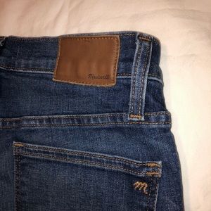 Madewell distressed skinny jeans.
